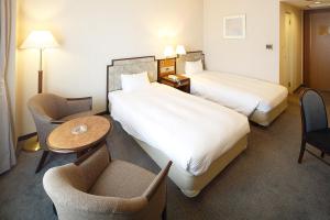 Säng eller sängar i ett rum på Hotel New Omi