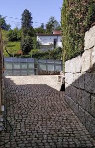 a stone walkway next to a stone wall at Casa Cosme in Braga