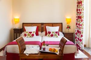 a bedroom with a bed with a tray of fruit on it at Casona de La Paca in Cudillero