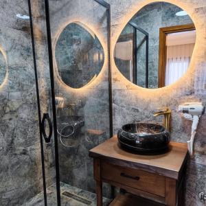 a bathroom with a sink and a shower with mirrors at Star Hotel in Istanbul