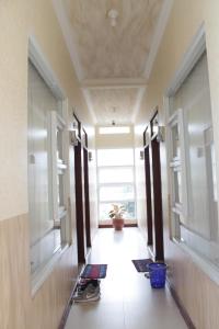 a hallway with windows and a floor with mats at G10 Guest House Near Asia Afrika Bandung in Bandung