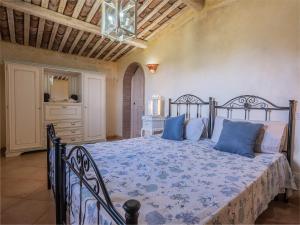 a bedroom with a bed with blue pillows at Sardinia Family Villas - Villa Elena with salt water private pool in Arzachena +46 photos