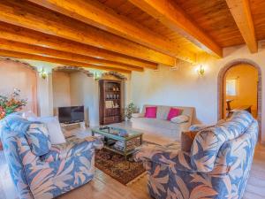 a living room with two couches and a tv at Sardinia Family Villas - Villa Elena with salt water private pool in Arzachena