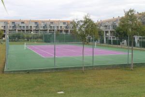 a tennis court with two trees on it at Appartement tout confort, Rez-de chaussée,3 chambres, 2 salles de bain in Sant Jordi