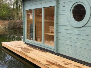 a house on a dock on a body of water at Cherry Trees in Stowmarket