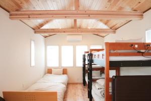 a room with bunk beds and a ceiling with beams at BATH B / Vacation STAY 54888 in Beppu