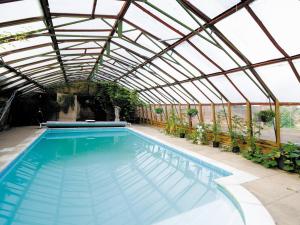 a swimming pool in a glass greenhouse with a swimming pool at Railway Carriage Two - E5601 in Wetheringsett