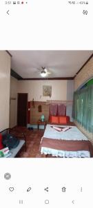 a bedroom with a bed and a table in it at Toni Arts Villa in Nabas