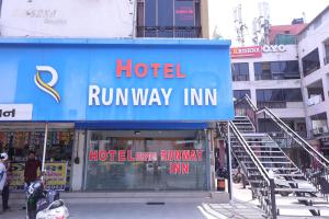 a hotel run way inn sign in a city at HOTEL RUNWAY INN in Ahmedabad