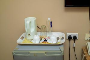 a coffee maker sitting on top of a washing machine at Spring Hills Hotel - Morogoro in Morogoro