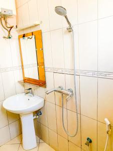 a bathroom with a sink and a shower at Spring Hills Hotel - Morogoro in Morogoro