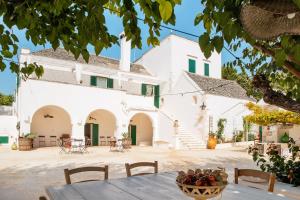 a table in front of a white building at Masseria San Michele in Martina Franca