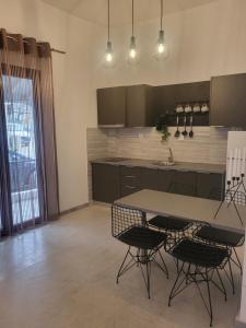 a kitchen with a table and chairs in a room at Athina's home 2 in Ayios Nikolaos Sithonia