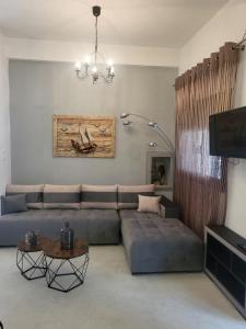 a living room with a couch and a table at Athina's home 2 in Agios Nikolaos