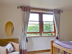 a bedroom with a bed and a window at Old Stones in Glendevon