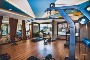 a gym with several treadmills and ellipticals in a room at KURT SAFİR EURO 20 RESIDENCE NO:15 in Alanya