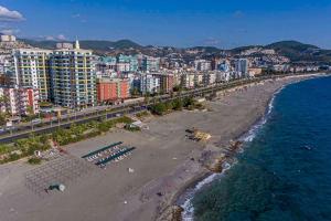 an aerial view of a beach with buildings and the ocean at KURT SAFİR EURO 20 RESIDENCE NO:15 in Alanya