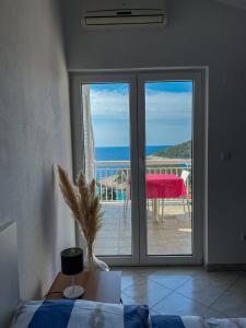 a room with a sliding glass door with a view of the ocean at Apartments Marija Magdalena in Hvar