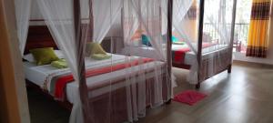 Katil atau katil-katil dalam bilik di Pearl View Guesthouse