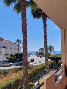 a view from the balcony of a condo with palm trees at Casa Verso Vera Playa in Vera