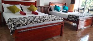 Katil atau katil-katil dalam bilik di Pearl View Guesthouse