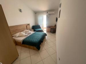 Ένα ή περισσότερα κρεβάτια σε δωμάτιο στο Guest House-MD