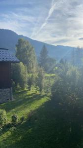 a view of a field with trees and a house at Three bedroom Apartment, Samoens, Grand Massif in Samoëns
