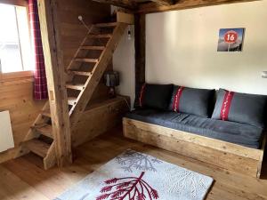 a living room with a couch and a wooden staircase at Three bedroom Apartment, Samoens, Grand Massif in Samoëns
