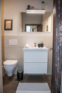 a bathroom with a white sink and a toilet at Bonaventura in Greve in Chianti +21 photos