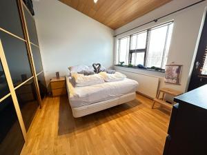 a bedroom with a bed with a teddy bear on it at Cosy and family friendly house in Reykjavik centrally located in Laugardalur in Reykjavík