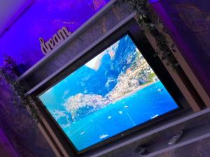 a television in a room with a purple ceiling at FANTASY ROOM in Iaşi
