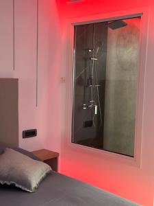 a bedroom with a window with a shower in it at FANTASY ROOM in Iaşi