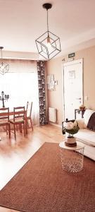 a living room with a couch and a table at COSTA NORTE Apartamento con Terraza Garaje y Piscina in Castro-Urdiales