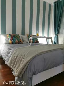 - une chambre dotée d'un lit avec un mur rayé dans l'établissement Dimora OltreMare, à Bari