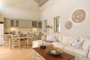 a living room with a couch and a table at Erkina Villas Kalami Corfu in Kalami