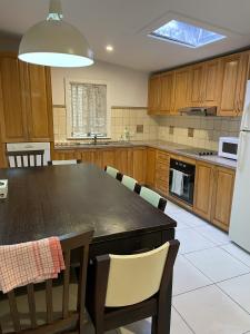 a kitchen with a large black table and chairs at LCF Rosehill Accommodation 3 free car parking inside property G2 in Sydney