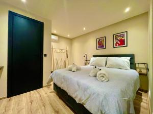 a bedroom with a large bed with towels on it at SoHo Loft in Alexandroupoli