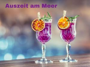 three wine glasses with orange slices in them on a table at Ferienwohnung mit Terrasse - Insel Usedom in Trassenheide