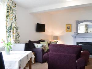 a living room with a couch and a table at The Cottage in Bridlington
