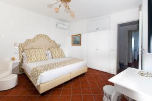 a bedroom with a bed and a table and a desk at AMORE RENTALS - Resort Ravenna - Villa Dama in Massa Lubrense +85 photos