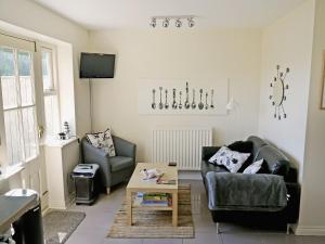 a living room with two chairs and a coffee table at Waterside in Warkworth