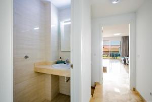 a bathroom with a sink and a mirror at Residencial Playa de La Arena in Puerto de Santiago