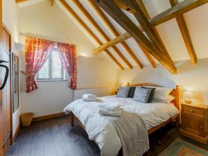 a bedroom with a large bed and a window at Pass the Keys The Stable in Norwich