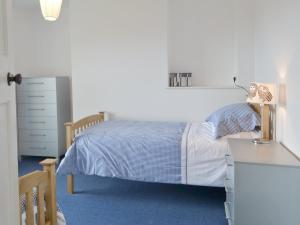 a small bedroom with a bed and a desk at Little Stretton in Bigbury on Sea
