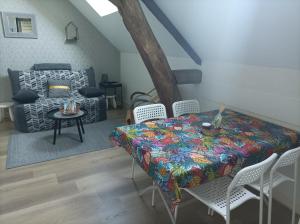 a room with a table and chairs and a bed at Gîte 4 pers, Jacuzzi privatif & Piscine & Lit cabane in Saint-Georges-sur-Cher
