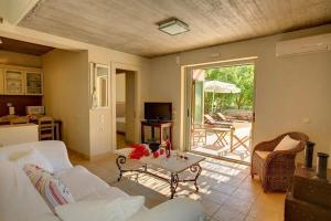 a living room with a couch and a table at Erkina Villas Kalami Corfu in Kalami