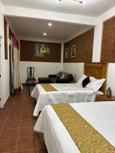 Voodi või voodid majutusasutuse Hotel Boutique Casona Mashei toas