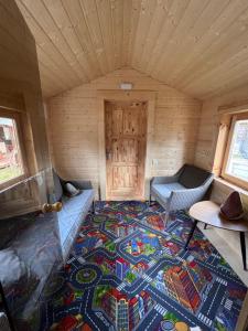 a room with a rug on the floor in a wooden cabin at Villa Arjola in Kaltanėnai