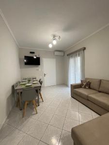 a living room with a couch and a table at Litsa's Apartment in Igoumenitsa