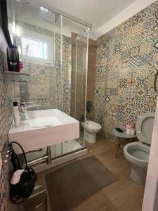 a bathroom with a sink and a toilet at CASA NENO in La Mareta +49 photos
